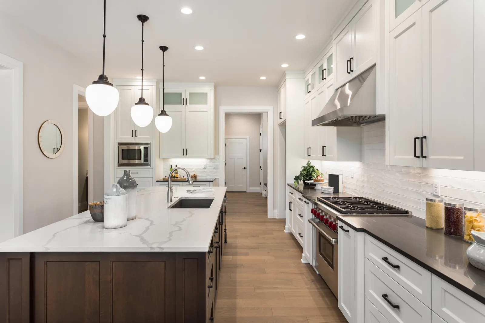 White shaker kitchen with a marble island and pendant lights