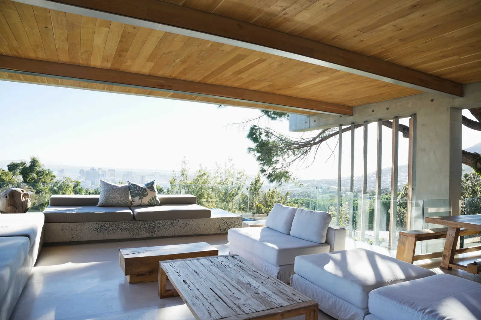 Covered terrace with a timber ceiling looking out over a city view