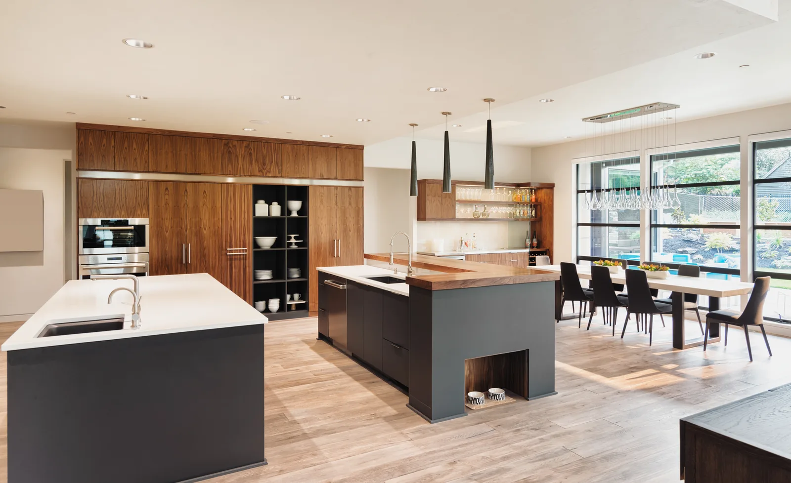 Renovated open-plan kitchen with a walnut wall of cabinetry and a long island